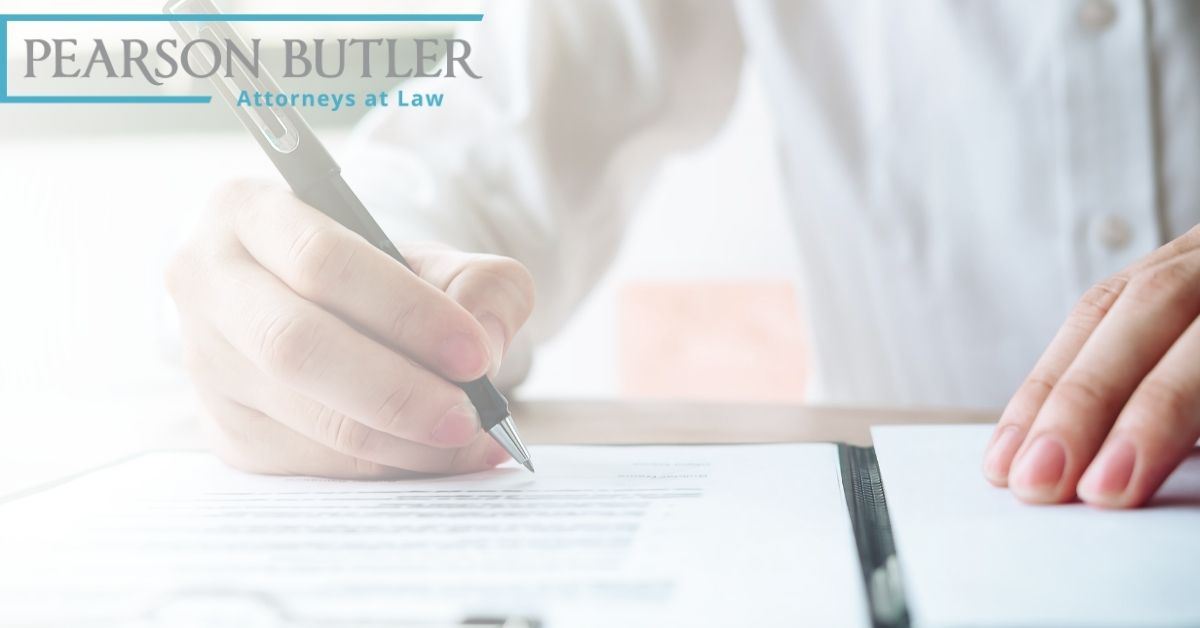 Man using pen to sign a paper